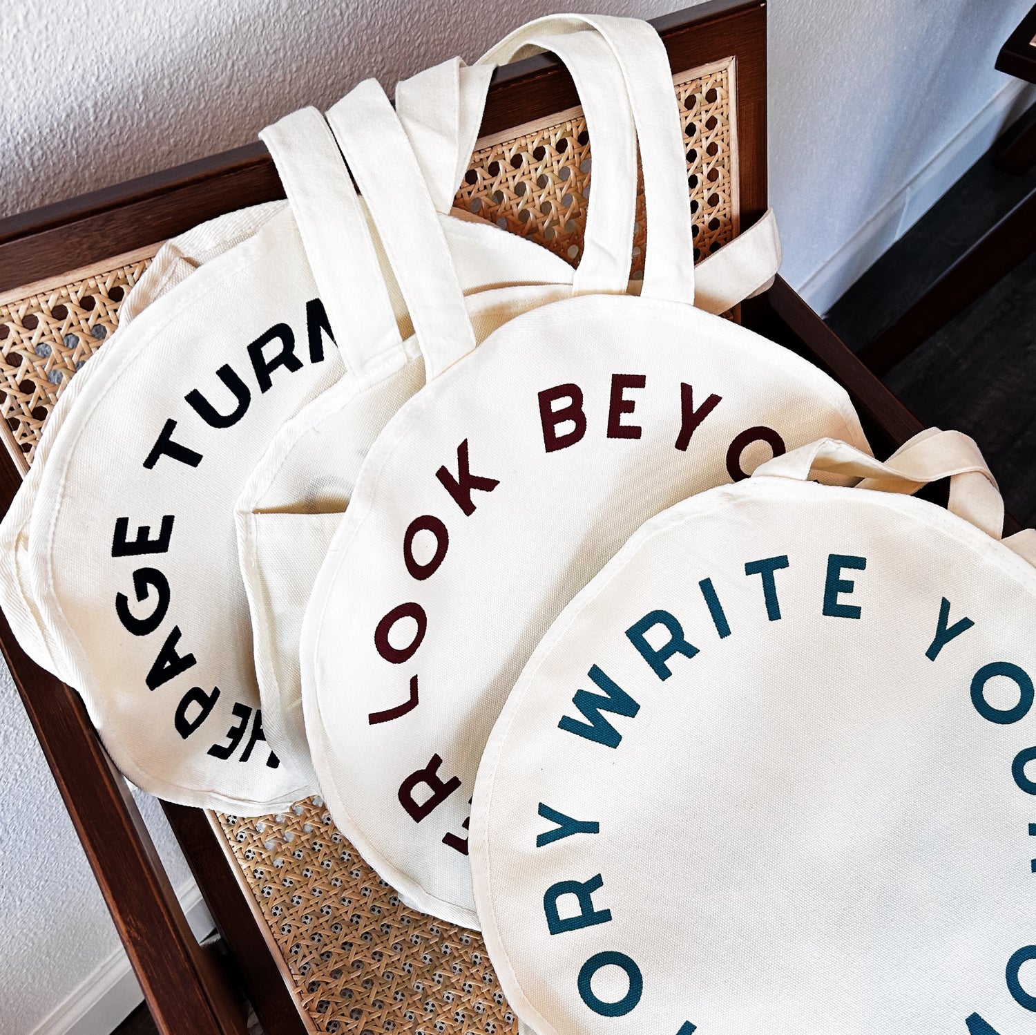 tote bag on display with coffee, flowers, and books